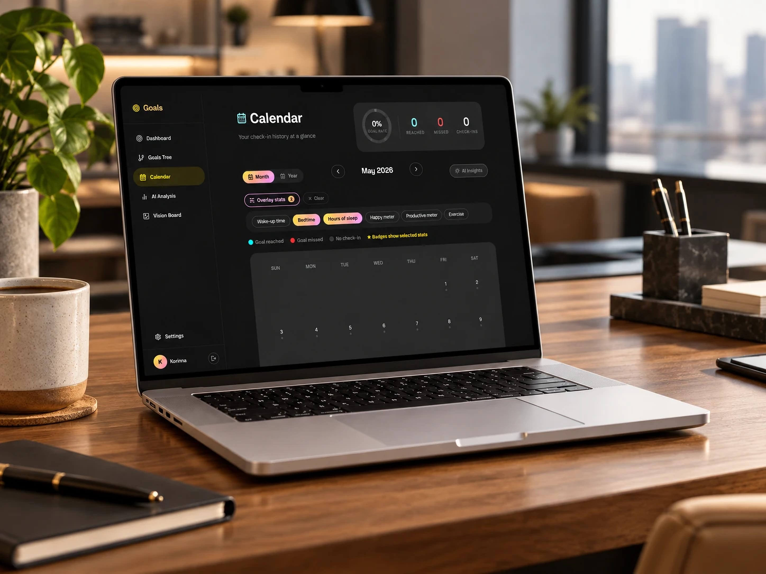Goals app open on its calendar view, on a laptop on a wooden desk.